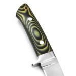 Close-up of black and green knife handle with concentric decorative patterns, silver-colored circular details and gold-rimmed opening.