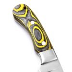 Close-up of black and yellow-green layered handle showing eye-shaped concentric patterns, silver circular details and metal bolster.