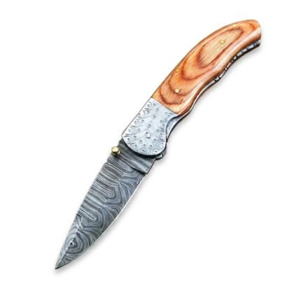 Decorative bolster folding knife shown open with a gray patterned blade, brown grain-look handle, silver-tone patterned bolster, and gold-tone thumb stud.