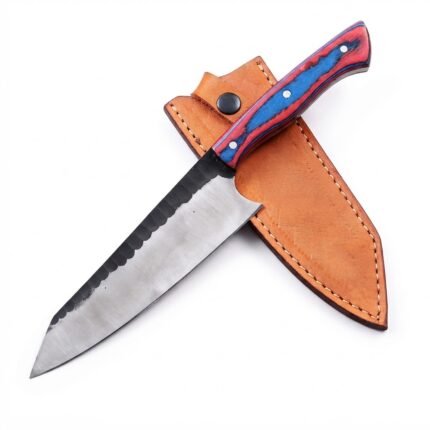 Red and blue chef knife with three silver-tone handle pins and a two-tone blade resting diagonally across a tan stitched sheath.