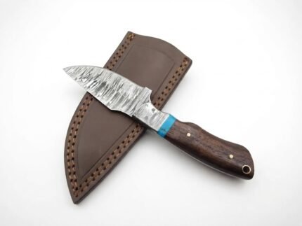 Blue Accent Wood Handle Hunting Knife with Damascus-style silver patterned blade, dark brown contoured handle, turquoise spacer and brown stitched sheath.