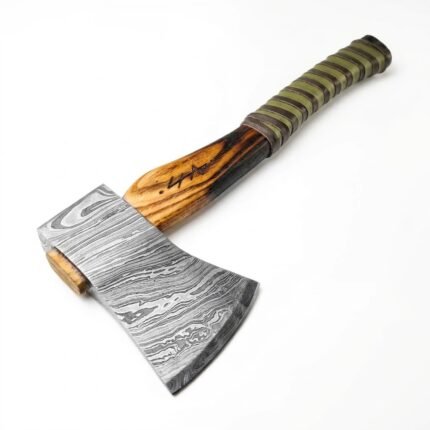 Damascus Steel Viking Axe featuring patterned silver-gray axe head, natural wooden handle and green and dark brown wrapped grip on a white background.