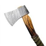 Damascus Steel Viking Axe featuring patterned silver-gray axe head, natural wooden handle and green and dark brown wrapped grip on a white background.