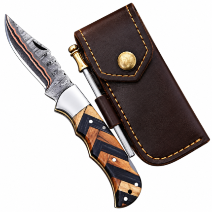 Open geometric handle folding knife with a black-and-tan handle and copper-tone patterned blade, beside a brown pouch and gold-handled rod accessory.