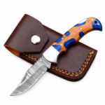 Blue Resin Accent Hunting Knife with Damascus-style patterned blade, blue-and-brown wood-grain handle, polished bolster, and brown stitched pouch.