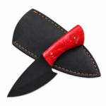 Red Handle EDC Knife with matte black drop point blade, glossy red marbled handle, and two brass-colored pins, held in a black-gloved hand