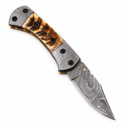 Damascus Pattern Pocket Knife shown partially open with a curved black-and-silver blade, tan wood-grain-look handle, patterned metal fittings and separate gold-ended rod.