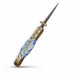 Blue Marble Damascus Folding Knife shown open with silver-gray patterned blade, blue-and-white marbled handle and gold-tone grid-patterned bolsters