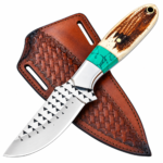 Turquoise accent fixed blade knife with triangular blade details and a cream-and-brown handle, resting diagonally over a brown basketweave-style sheath.
