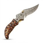 Wavy Handle Damascus Folding Knife with curved patterned blade, black and copper-brown sculpted handle, ornate silver pivot and brown snap-closure pouch.