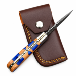 Blue Resin Accent Hunting Knife with Damascus-style patterned blade, blue-and-brown wood-grain handle, polished bolster, and brown stitched pouch.