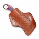 Red Blue Handle Karambit Knife with black curved claw blade, textured metallic finish, red-and-blue handle, gold-colored pins and circular finger ring