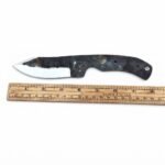 Rustic Black Skinner Knife Blank with mottled dark blade, curved silver cutting bevel, exposed full tang and four visible handle holes