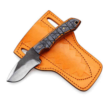 Black and orange skinner hunting knife with a broad curved two-tone steel blade, textured crisscross handle, brass-colored pins, and lanyard hole
