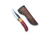 Red and Black Wood Handle Fixed Blade Hunting Knife with polished and dark two-tone blade beside a brown basketweave-style sheath
