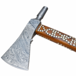 Close-up of Viking axe head showing intricate Damascus-style flowing pattern and broad curved metallic blade