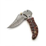 Wavy Handle Damascus Folding Knife with curved patterned blade, black and copper-brown sculpted handle, ornate silver pivot and brown snap-closure pouch.