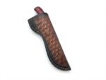 Red and Black Wood Handle Fixed Blade Hunting Knife with polished and dark two-tone blade beside a brown basketweave-style sheath