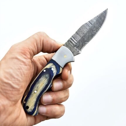 Blue and Cream Damascus Pattern Folding Knife shown open with a silver-grey wave-pattern blade, polished bolster, and blue and cream swirled handle.