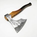 Engraved Viking Axe featuring a silver curved axe head with dark geometric Nordic-style markings and a long golden-brown wooden handle with black lower finish