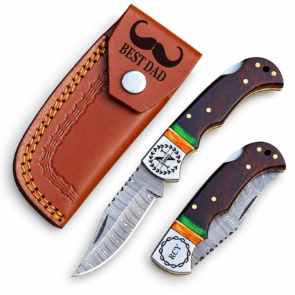 Personalized Damascus Folding Knife shown open and closed with patterned blade, engraved bolster and brown wood-grain handle