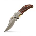 Wavy Handle Damascus Folding Knife with curved patterned blade, black and copper-brown sculpted handle, ornate silver pivot and brown snap-closure pouch.