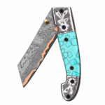 Turquoise Handle Damascus Folding Pocket Knife with silver floral engraved fittings, pocket clip, patterned angular blade and copper-colored accent