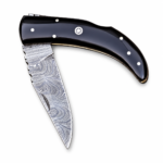 Damascus Pattern Folding Knife with silver-gray layered blade design, curved glossy black handle, silver-colored pins and circular decorative accent