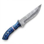 Blue grain handle knife with a broad gray patterned blade, copper-tone divider, four silver-tone pins, a mosaic-style pin, and a rear lanyard opening.