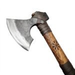 Viking Bearded Axe featuring a curved steel-look blade, wooden handle with carved decorative motif and dark brown leather-style wrapping on white background.
