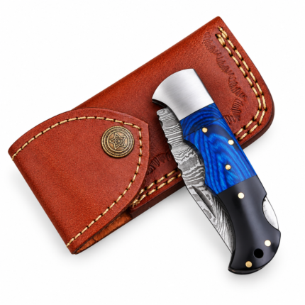 Close-up of Blue Handle Damascus Hunting Knife showing flowing silver-grey wave patterns and pointed blade profile