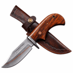 Premium Damascus hunting knife with a curved patterned blade, reddish-brown wood-grain handle, silver-tone finger guard, red mosaic pin, and lanyard hole