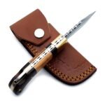 Brown Wood Handle Damascus Pattern Hunting Knife with a curved silver-gray patterned blade, gold-tone bolster, multitone wooden-look handle, and metallic pins