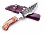Hammered Pattern Hunting Knife with dark circular blade detailing, silver bevel, light brown wood-grain-look handle and burgundy double-strap sheath.