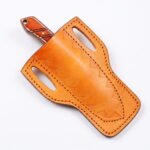Compact Curved Skinner Knife with broad two-tone blade, brown and cream wood-grain-style handle and tan stitched belt sheath with snap closure.
