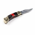 Ornate Black and Red Folding Knife shown open with a satin silver blade, black handle sections, red marbled inlay and floral engraved gold-tone bolsters
