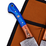 Five-piece blue handle kitchen knife set with patterned gray blades, brown handle accents, decorative pins, and a broad central cleaver-style knife.