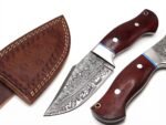 Damascus-Pattern Hunting Knife with silver-gray wavy blade, polished metal bolster, reddish-brown wooden handle and brown stitched sheath