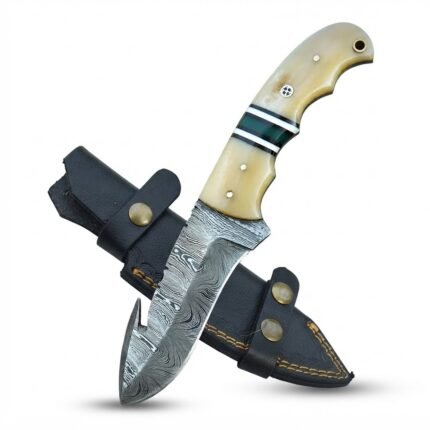 Cream Handle Damascus Pattern Gut Hook Hunting Knife with curved silver patterned blade, green handle spacers and black stitched sheath