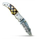 Engraved Bolster Damascus Folding Knife with patterned curved blade, brown and black checkered handle, floral metal fittings and brown stitched sheath.