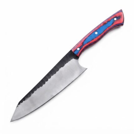 Red and blue chef knife with three silver-tone handle pins and a two-tone blade resting diagonally across a tan stitched sheath.