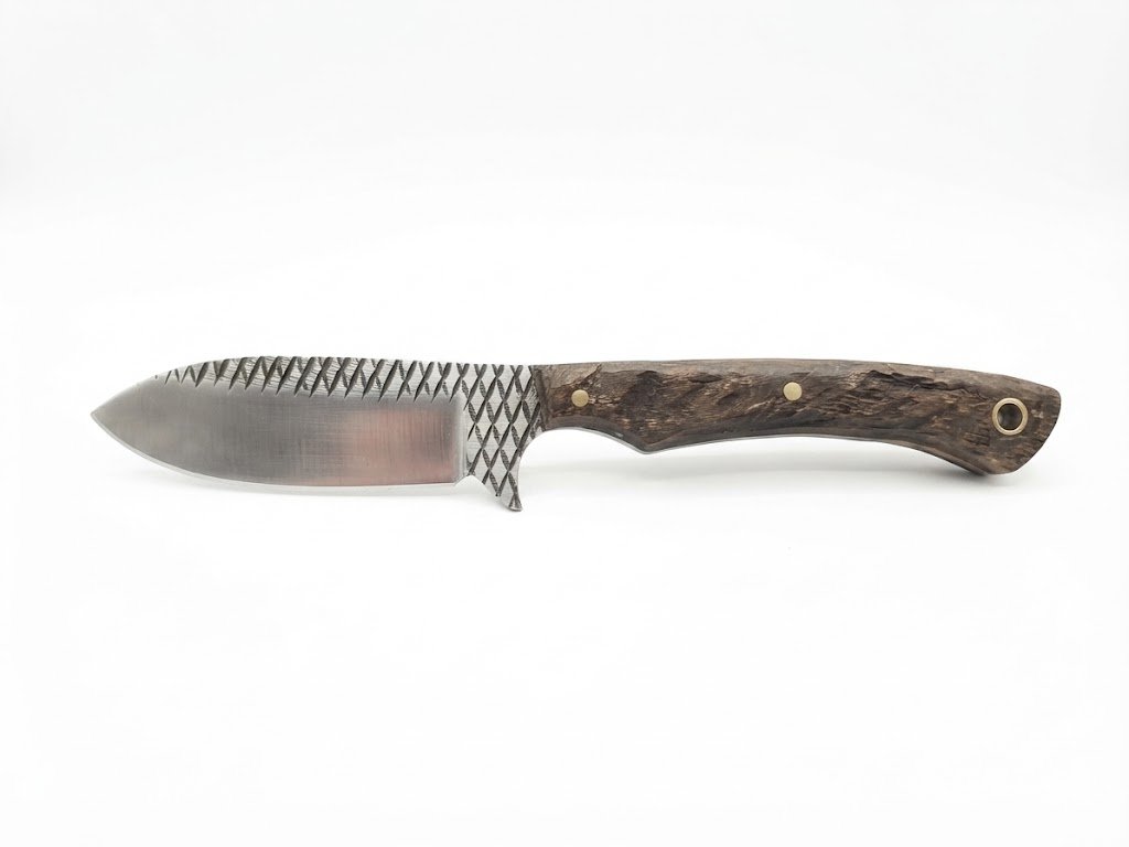 bd56d8ef-c0db-4f87-a7bc-f5dde61f62b1 Decorative filework hunting knife with satin silver blade, dark crosshatched markings, brown wood-grain handle, brass-colored pins and rear lanyard hole.