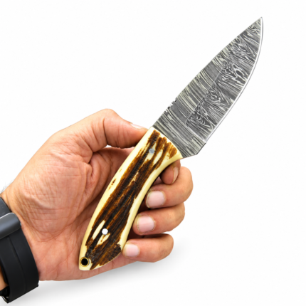 Antler Look Hunting Knife with silver-gray patterned blade, cream and brown textured handle, and black sheath decorated with oak leaves and acorns