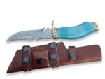 Turquoise Handle Damascus Pattern Knife with curved silver-gray blade, decorative gold-tone guard, blue patterned grip and brown multi-strap sheath.