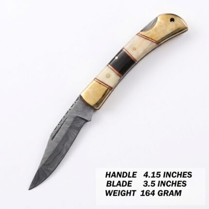 Damascus Pattern Belt Knife with a pointed silver-gray patterned blade, cream-and-black segmented handle, gold-tone fittings and brown basket-weave sheath.