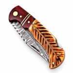 Damascus-style fixed blade knife handle with reddish-brown wood-look section, gold-colored spacers and curved finger contours