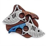Damascus Pattern Mini Cleaver Knife with curved silver-gray patterned blade, circular and triangular cutouts, brown wood-grain handle and embossed sheath.