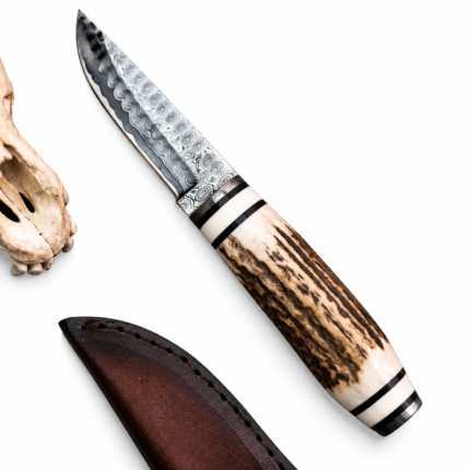 Stag handle Damascus hunting knife with patterned blade and cream brown antler-style grip