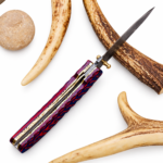 Red Blue Damascus Folding Knife shown open with a pointed silver-gray patterned blade, gold-colored thumb stud and ribbed red-and-blue handle.