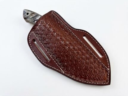 Bone Accent Damascus Hunting Knife with curved patterned blade, cream and dark horn-like handle, and embossed brown sheath